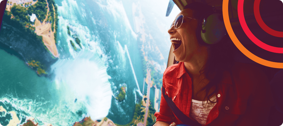 Woman laughing in airplane over skyline